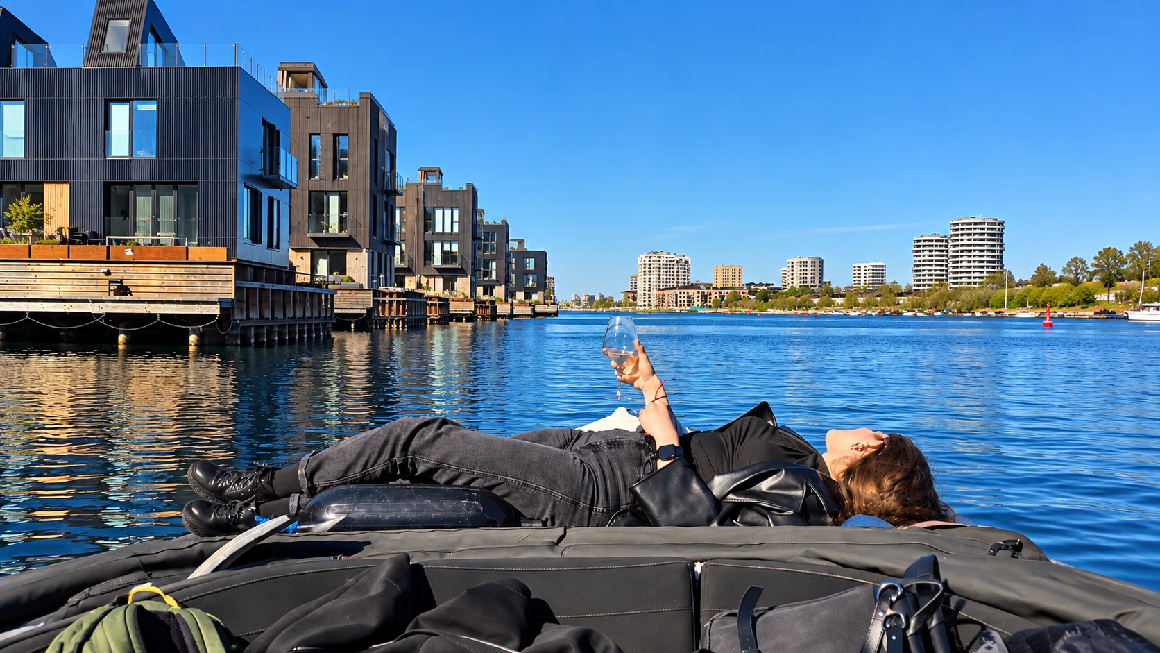Guest relaxing with a glass of wine aboard the boat in Copenhagen's harbor